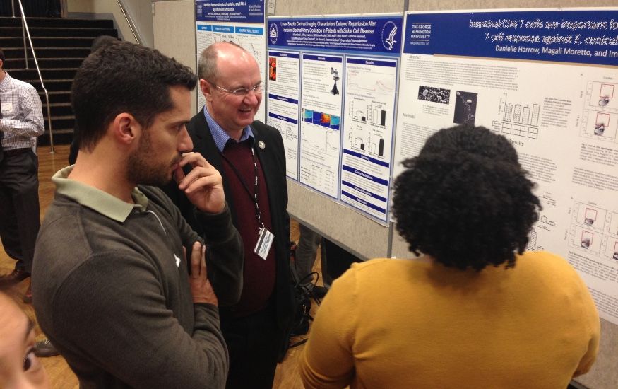 MITM postdocs and students presenting posters at the GWU 2015 Research days - Danielle Harrow with Douglas Nixon and Fabio Leal